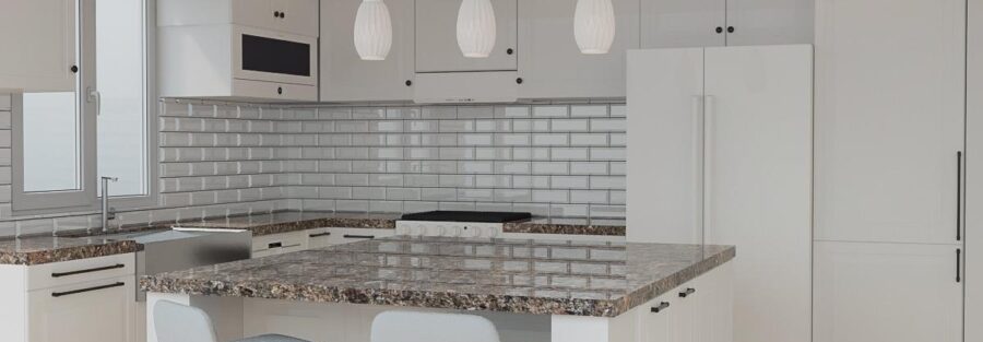 Bright and modern newly remodeled kitchen with marble countertops and stainless steel appliances.